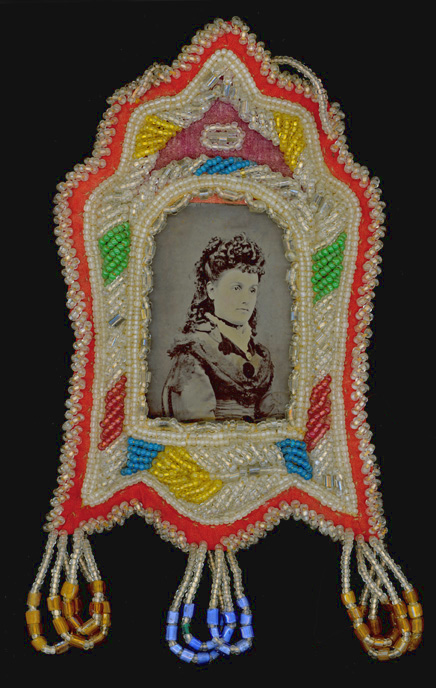 A daguerreotype is still framed by this beaded souvenir.